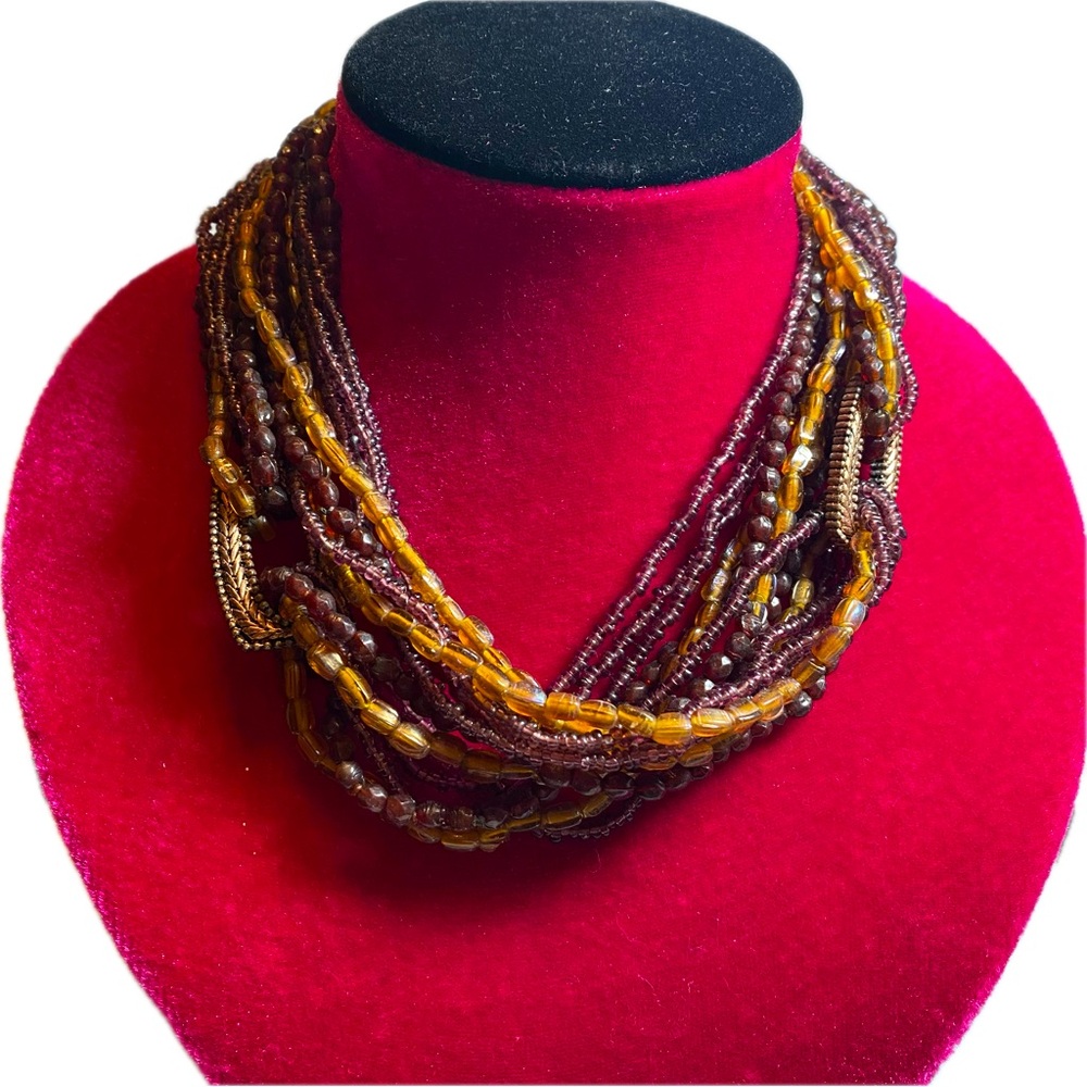 Multi strand necklace. Shades of brown beads. Copper color findings.